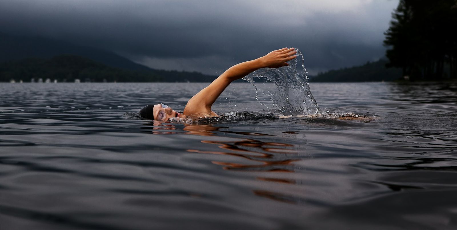 A swimmer reaching forward in open-water freestyle